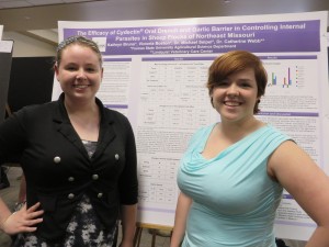 Katie Bruno and Victoria Boston showing findings from research of parasite medicine effectiveness.