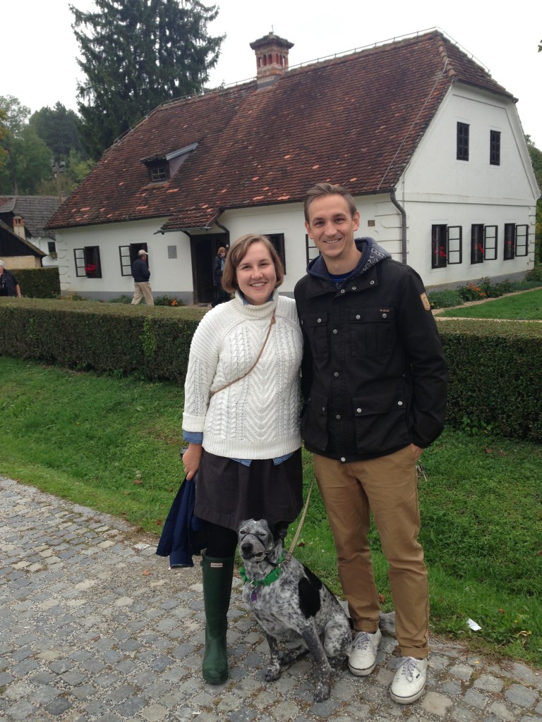 Prof. Heidi Cook, her husband Brent, and Pumpkin, in Kumrovec, Croatia in front of the house where Yugoslavian dictator Josip Broz Tito was born.